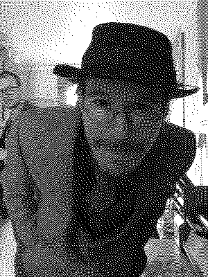black and white photo of a man in a suit and hat