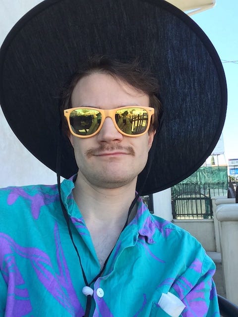 human wearing sunglasses and a big black circular hat