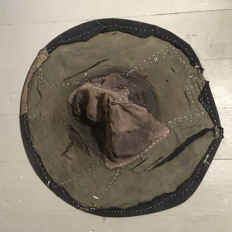 top of black hat showing white stitching