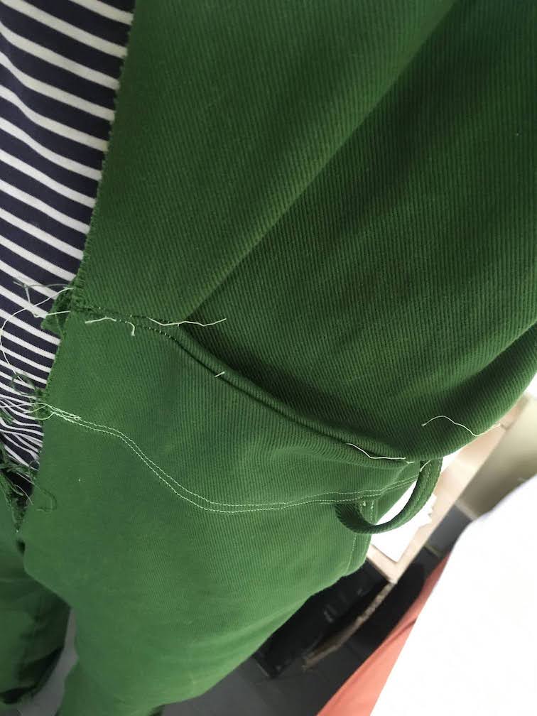 looking down the front of the jumpsuit at an odd angle showing the pinch points