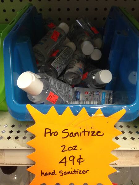 a picture of a bin of hand sanitizers with a sign that reads, "Pro Sanitize 2oz 49¢ hand sanitizer