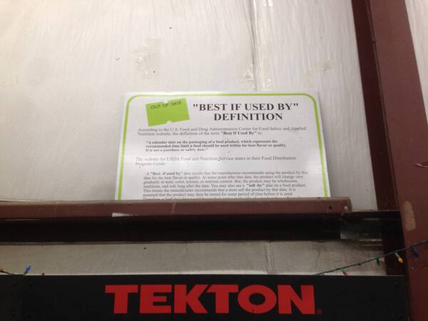 a sign that reads '"BEST IF USED BY" DEFINITION' and then has a long definition that is cut off by the beam the sign is sitting on